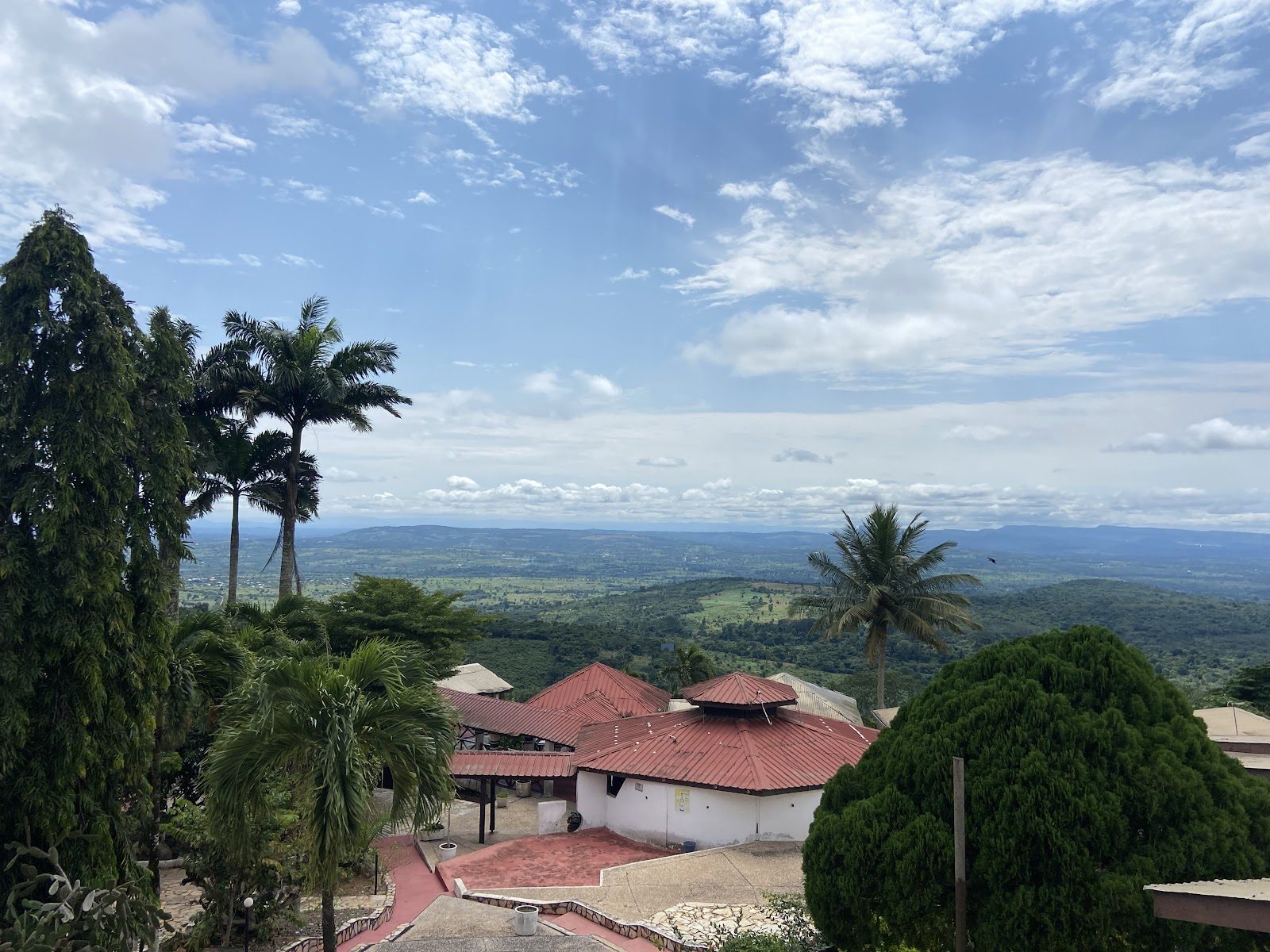 Wide view across the green Akuapem ridge from Palm Hill Hotel