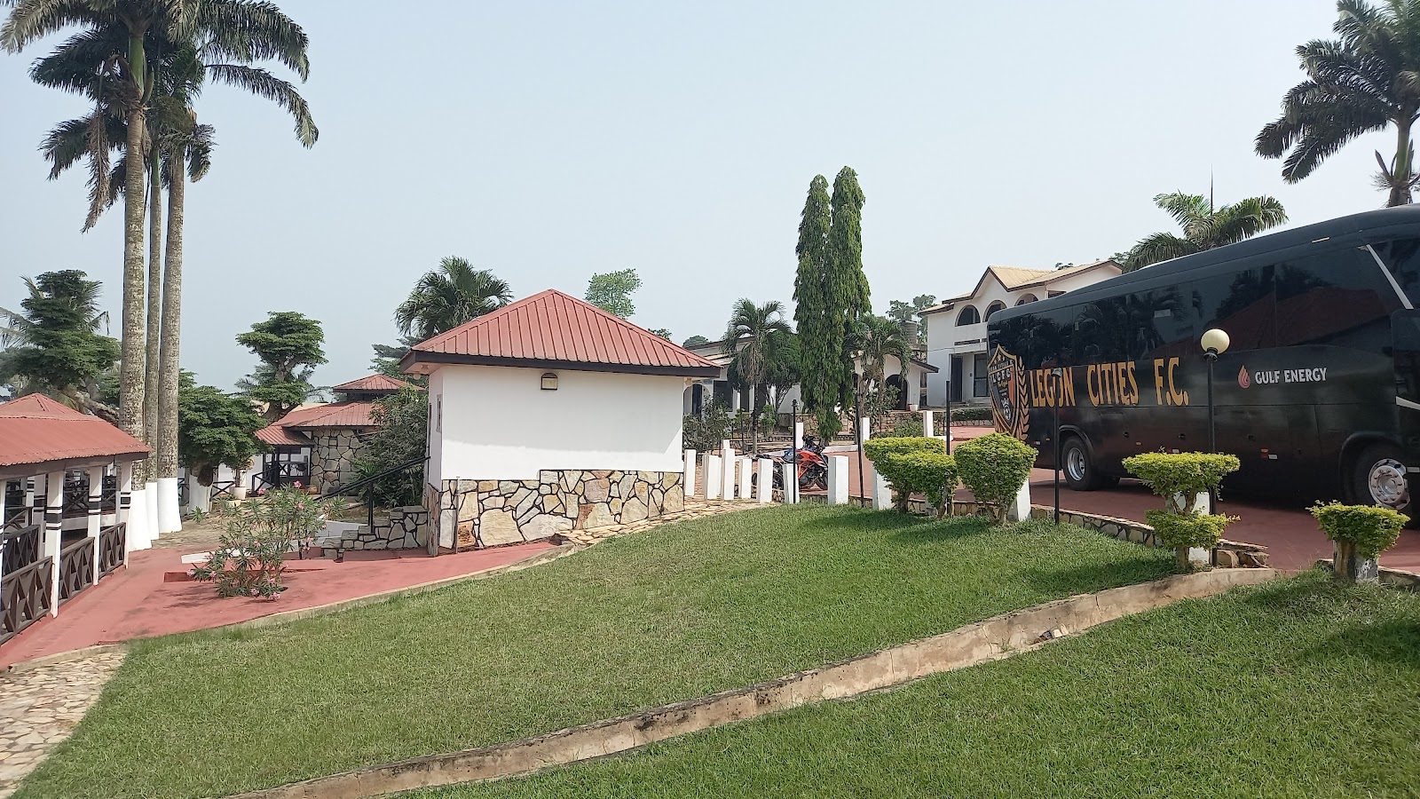 Lawn, buildings and palms on the Palm Hill Hotel grounds